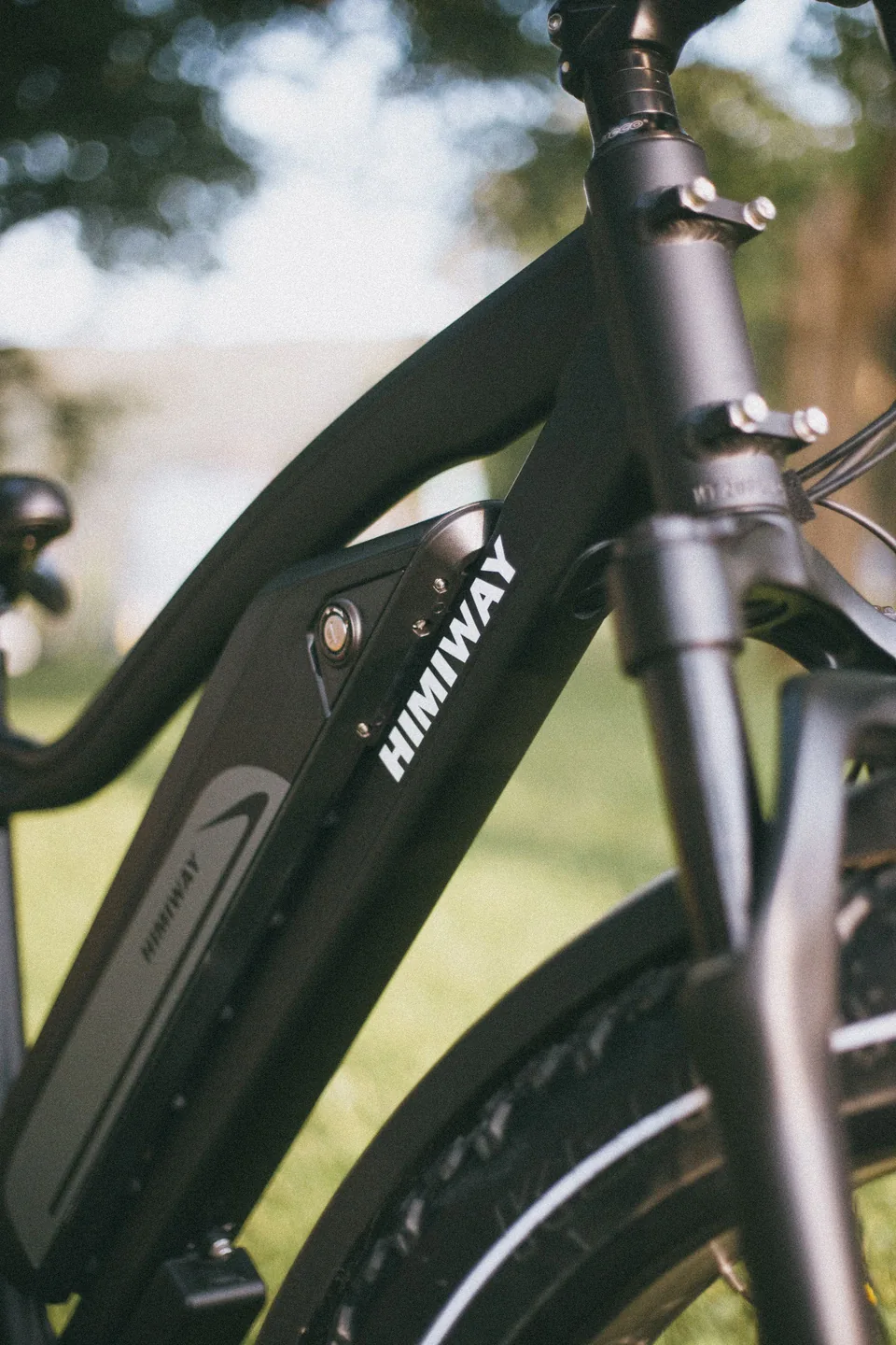 Close-up of a black electric bicycle battery and frame; lifestyle imagery, not a catalogue product